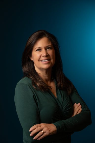 Headshot of a woman with a blue background