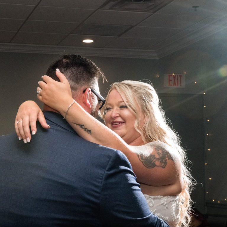 Bride and Groom look at each other lovingly on their first dance