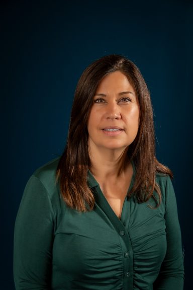 Headshot of a woman with a blue background