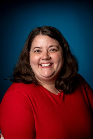 Headshot of a woman with a blue background